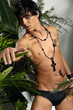 Photo: Young male model in green forest background Young male model in green forest background
