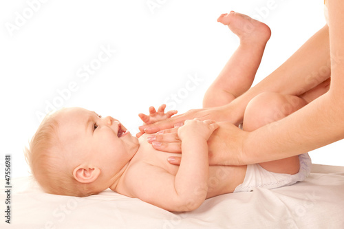 Photo: Baby massage. Mother massaging kid belly, baby laughing. Baby massage. Mother massaging kid belly, baby laughing.