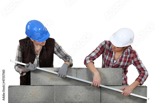Photo: duo of female bricklayers duo of female bricklayers