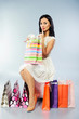 Photo: Beautiful girl taking out her present from shopping bag Beautiful girl taking out her present from shopping bag