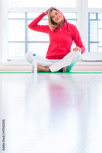 Photo: Pretty young woman doing YOGA exercise at home Pretty young woman doing YOGA exercise at home