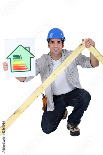 Photo: Tradesman holding a frame and an energy efficiency rating chart Tradesman holding a frame and an energy efficiency rating chart