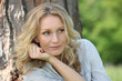 Woman smiling under tree