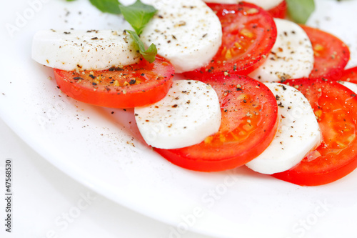 Photo: Tomato and mozzarella slices on a plate Tomato and mozzarella slices on a plate