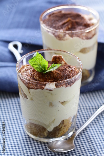 Photo: Traditional Italian dessert tiramisu in a glass beaker Traditional Italian dessert tiramisu in a glass beaker