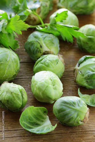 Photo: fresh raw brussels sprouts on a wooden table fresh raw brussels sprouts on a wooden table