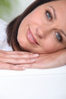 Brunette resting in bed