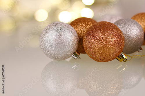 Photo: Christmas baubles over shiny lights background Christmas baubles over shiny lights background