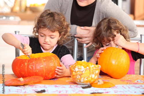 Photo: Children carving halloween pumpkins Children carving halloween pumpkins