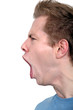 young man in profile shouting angrily