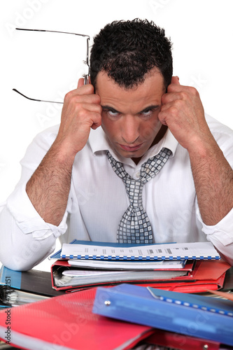 Photo: Frustrated businessman with files Frustrated businessman with files