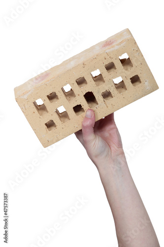 Photo: Hand holding a house brick Hand holding a house brick
