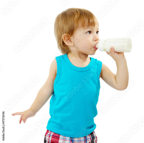 Photo: cute little boy with bottle of milk, isolated on white cute little boy with bottle of milk, isolated on white