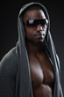 Black fitness man urban style with dark sunglasses. Studio shot.
