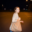 Scared woman running from her pursuer in a deserted parking