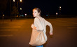 Scared woman running from her pursuer in a deserted parking