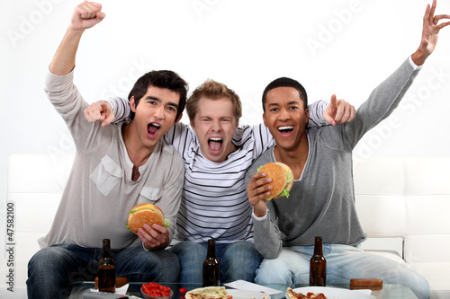 Photo: Friends watching a football game together Friends watching a football game together