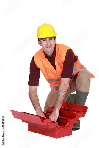 Photo: Worker tidying up his toolbox Worker tidying up his toolbox