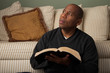 Photo: African American Studying the Bible at Home African American Studying the Bible at Home