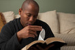 Photo: African American Studying the Bible at Home African American Studying the Bible at Home