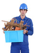 Construction worker recycling old wood