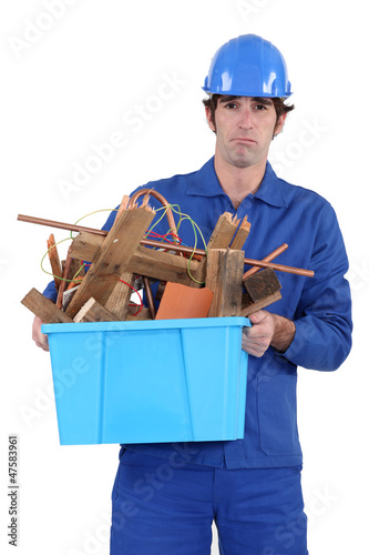 Photo: Construction worker recycling old wood Construction worker recycling old wood