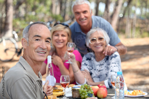 Photo: Older people eating in a field Older people eating in a field