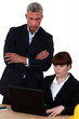 director examining the work of an employee