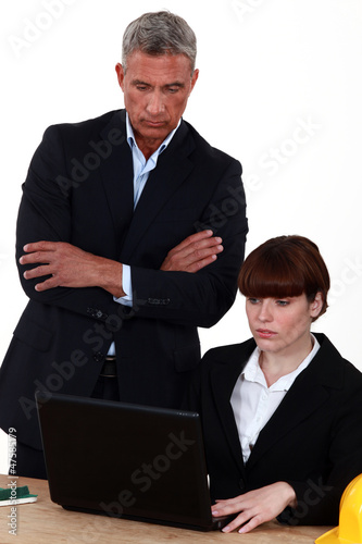 Photo: director examining the work of an employee director examining the work of an employee