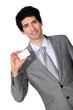 portrait of handsome businessman holding business card