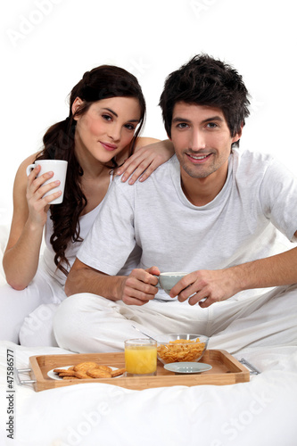 Photo: Couple having breakfast in bed Couple having breakfast in bed
