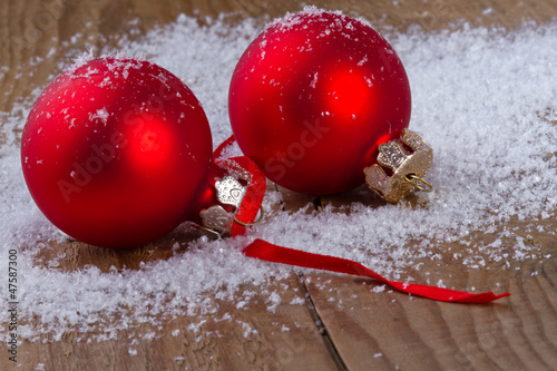 Photo: Christmas red balls on wooden background Christmas red balls on wooden background