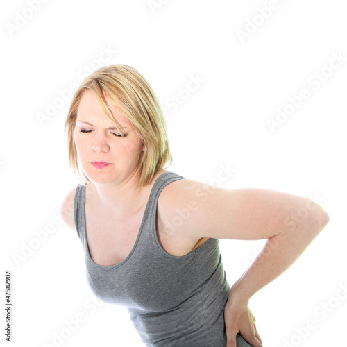 Photo: Young woman with back pain Young woman with back pain