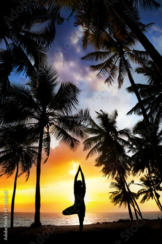 Photo: Yoga tree pose around palm trees Yoga tree pose around palm trees