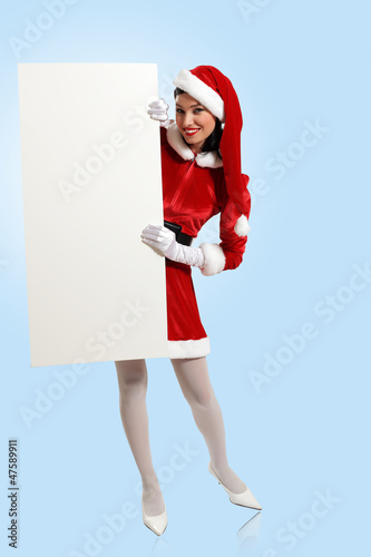 Photo: santa girl with a blank banner santa girl with a blank banner