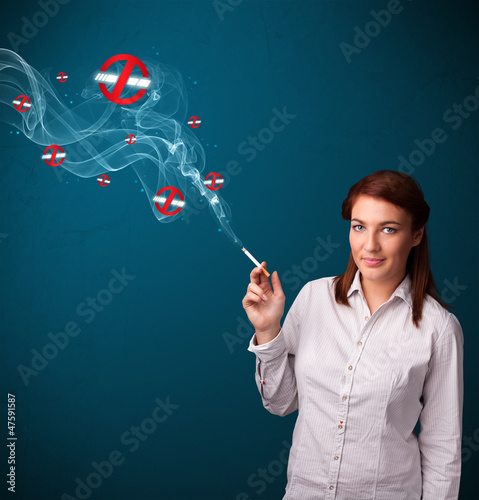 Photo: Young woman smoking dangerous cigarette with no smoking signs Young woman smoking dangerous cigarette with no smoking signs
