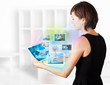 Young woman browsing pictures on modern tablet