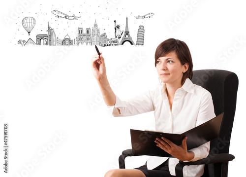 Photo: Young woman drawing famous cities and landmarks on whiteboard Young woman drawing famous cities and landmarks on whiteboard