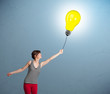 Pretty lady holding a light bulb balloon