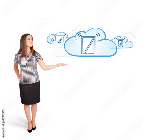 Photo: young woman presenting modern devices in clouds young woman presenting modern devices in clouds