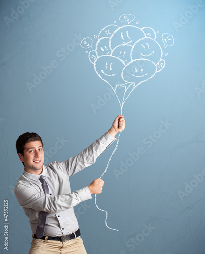 Photo: Happy man holding smiling balloons drawing Happy man holding smiling balloons drawing