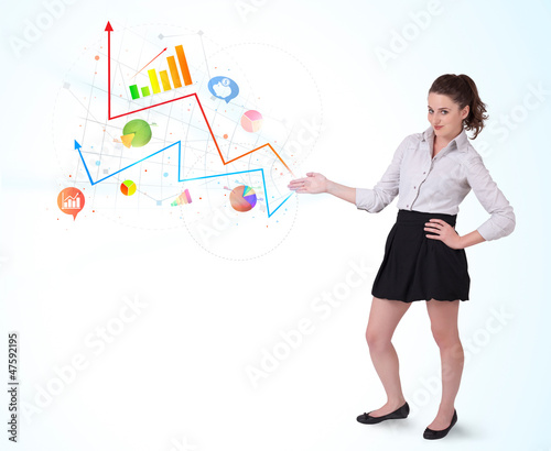 Photo: Young business woman presenting colorful charts and diagrams Young business woman presenting colorful charts and diagrams