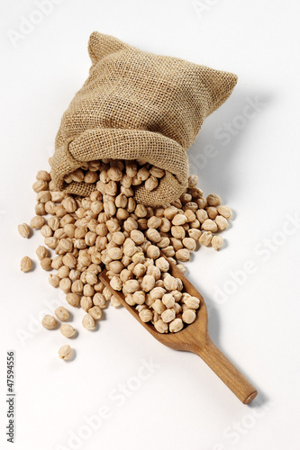 Photo: chickpeas in sack with wooden spoon chickpeas in sack with wooden spoon