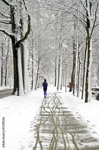 Photo: People jogging in winter in the forest People jogging in winter in the forest