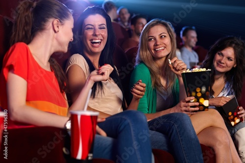 Photo: Happy girls in multiplex movie theater Happy girls in multiplex movie theater