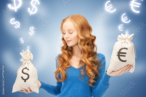 Photo: woman with euro and dollar bags woman with euro and dollar bags