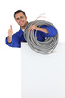 Electrician with long cable giving the thumbs-up