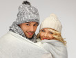 family couple under warm blanket