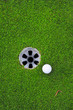 golf ball on lip of cup
