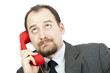 Photo: Businessman rolling his eyes as he listens to a phone call Businessman rolling his eyes as he listens to a phone call
